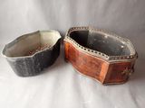 two old wooden boxes sitting next to each other on a white surface