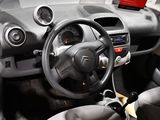 a car dashboard with a steering wheel and dashboard buttons