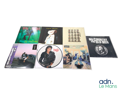 a lot of cd ' s sitting on a white surface