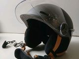 a helmet that is sitting on the floor next to a pair of shoes