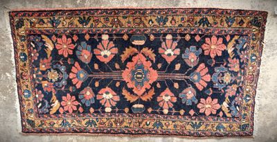 an old rug with a floral design on it