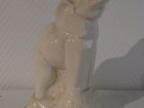 a white statue of a woman holding a baby