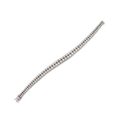a close up of a diamond bracelet on a white background