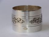 a close up of a silver ring on a white surface