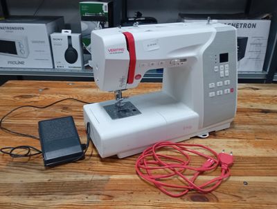 a sewing machine that is sitting on a wooden table