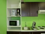 a small kitchen with a microwave and a microwave oven