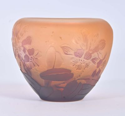 a glass vase that has a flower design on it