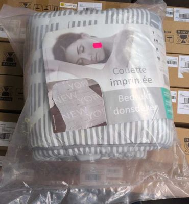 a pillow that is wrapped in plastic on a table
