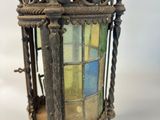an image of a very old looking lantern hanging on a wall