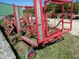 a red cart that is sitting in the grass