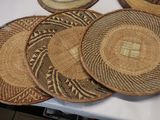 several woven baskets sitting on top of a table next to each other