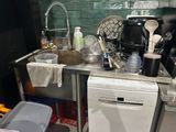 a kitchen with a sink, dishwasher, and a dishwasher