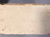 someone is holding a piece of paper that has been left on the table