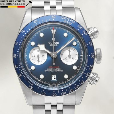 a close up of a watch with a blue face
