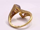 yellow gold ring with pink sapphires and diamonds on a white background