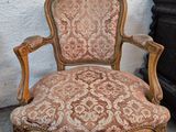 a chair that is sitting in front of a dresser