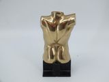 gold male torso sculpture on black base on white background