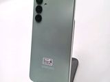 a close up of a phone on a stand on a white surface