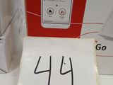 a sign on the table with a phone and a box