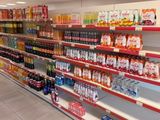 many shelves in the store with drinks and drinks on them