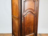 an old wooden cabinet sitting on top of a hard wood floor