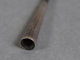 a close up of a metal pipe on a gray surface