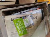 a box full of newspapers sitting on the floor