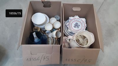 two boxes with items in them sitting on the floor