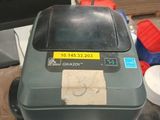 a trash can with a sticker on it sitting on a table
