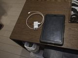 a cell phone on a table with a charger on it