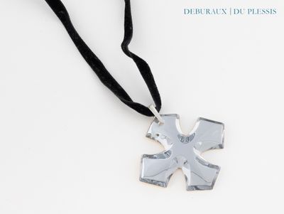 silver cross pendant with black ribbon on a white background