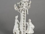 figurine of a man on a ladder and a woman on a ladder