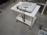 a table with a laptop and a phone on top of it