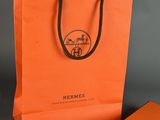 orange and blue gift bag with black handle and a blue gift bag with a black handle and a blue gift bag with a black handle and a blue gift bag with