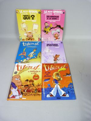 quatre livres pour enfants sont alignés sur une surface blanche