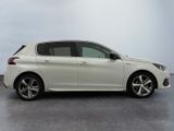 the white car is parked on the concrete floor in the room