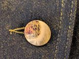 a close up of a button on the back of a jacket