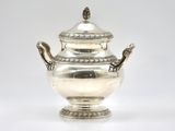 an antique silver teapot on a white surface with a white background