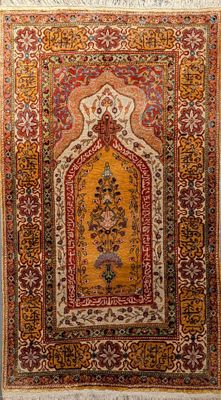 an antique persian rug with a floral design on a beige ground