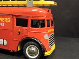 a toy fire truck with a ladder on top of it