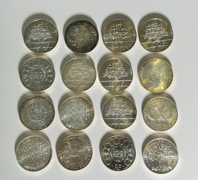 a lot of coins that are on a white surface