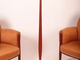 pair of orange chairs and a red floor lamp on a white background