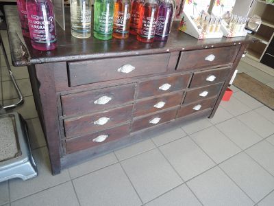 many bottles of alcohol on a dresser in the kitchen