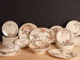a lot of plates and bowls on the table