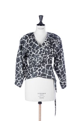 a white mannequin torso with a black and white giraffe print top