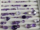 purple amethorate and other gems displayed in a display case