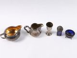 a group of silver and glass items on a white surface