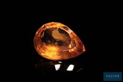 a yellow diamond on a black surface
