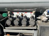 an image of a truck with a bunch of pipes on the back of it