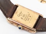 a close up of a wrist watch with a gold plated case